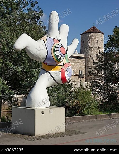 NIKI DE SAINT-PHALLE. Modern art on the banks of the Leine river, sculpture Nana by artist Niki de Saint Phalle, in the back Beginenturm, Hanover, Lower Saxony, Germany, Europe.