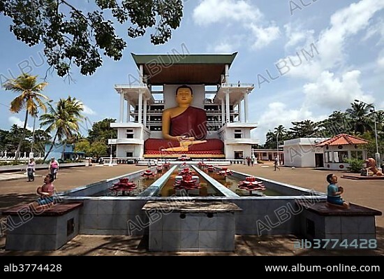 Giant Buddha statue, sitting Buddha fountain with artificial lotuses, Weherahena Temple, Matara, Southern Province, Sri Lanka, Asia.