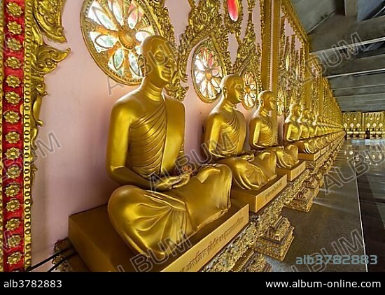 Row of golden Buddha statues in the corridor of the Phra Maha Chedi Chai Mongkhon Pagoda, Wat Pha Nam Yoi Temple, Phuttha-Utthayan Park, Province Roi Et, Isan, Northeast, Thailand, Asia.