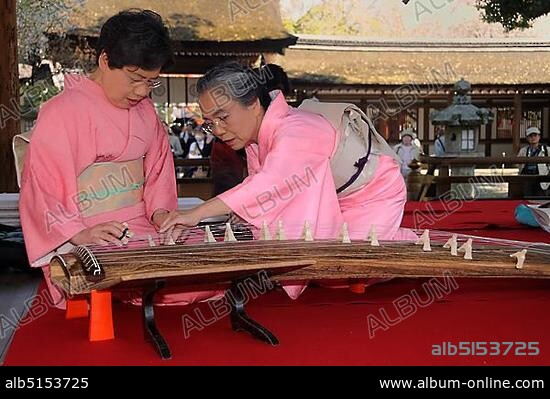Women playing a Koto, a traditional Japanese stringed musical instrument, Kyoto, Japan, Asia.