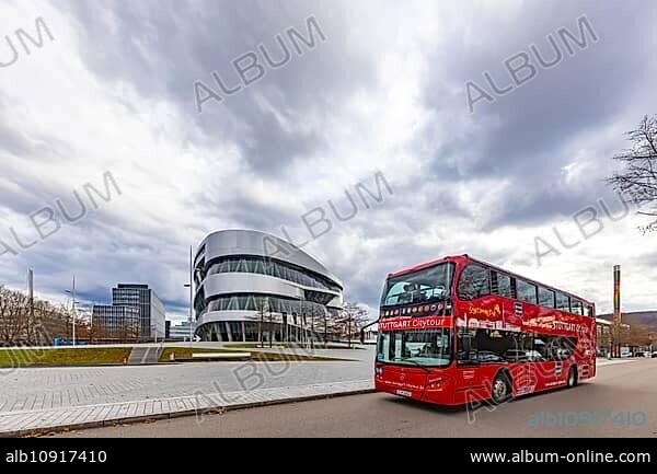 Stuttgrt Citytour. City tour in a red double-decker. City view of Stuttgart in front of the Mercedes-Benz Museum and the Mercedes Benz World in Bad Cannstatt, Stuttgart, Baden-Württemberg, Germany, Europe.