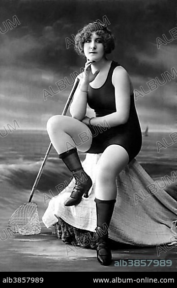 Fashion, swimwear, woman in swimsuit, shoes and stockings sitting by the sea, scenery, 1920s, Germany, Europe.