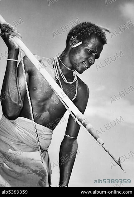 African with harpoon, historical photo, circa 1920.