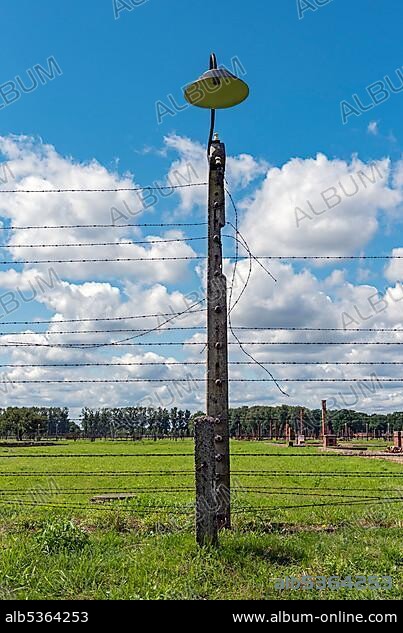 Barbed-wire fence and lamp-post at Auschwitz II-Birkenau concentration camp, Oswiecim, Poland, Europe.