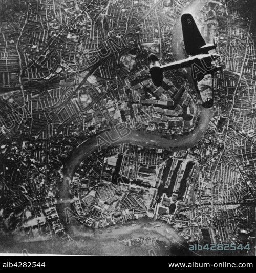 German Heinkel He-111 bomber of the Luftwaffe. flying over the India Docks of London, during the Blitz, September 7, 1940.