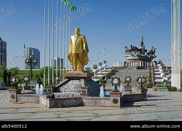 Gold covered statue of President Turkmenbasy in front of the monument of the 10th anniversary of Independence and Akhal-teke horses fountain, Ashgabat, Turkmenistan, Asia.