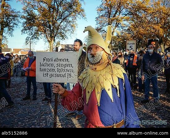 A man dressed as a joker with a Hitler beard, demonstration against corona measures of the Querdenken-Bündnis on 14.11.2020 in Schrobenhausener Straße, Aichach, Bavaria, Germany, Europe.
