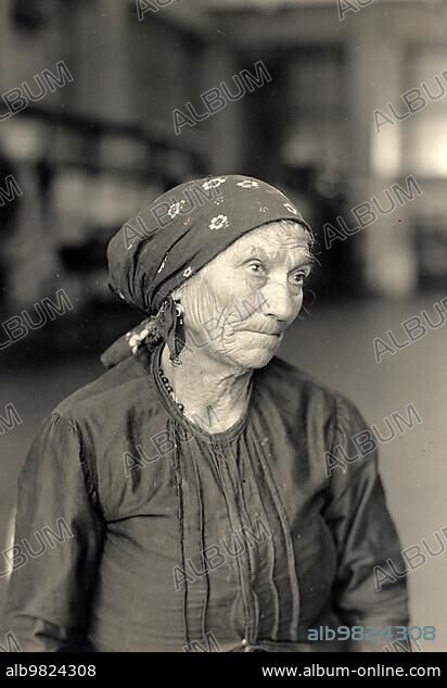 Italian immigrants; old woman in Ellis Island; America; photograph by Lewis Wickes Hine (1874-1940); Historic; digitally restored reproduction from a 19th century original.