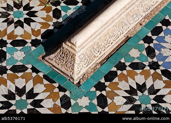 Arabic gravestone with arabesque inscription surrounded by coloured tiles, Saadien Tombs, Medina, Morocco, Africa.
