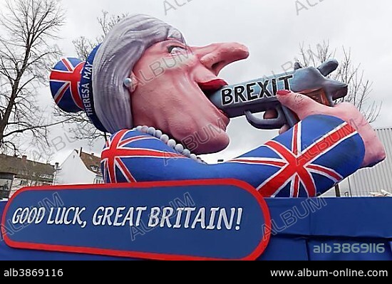 British Prime Minister Theresa May holds gun in her mouth, suicide by Proposed referendum on United Kingdom membership of the European Union, paper mache figure, slogan cart Carnival Monday procession 2017, Düsseldorf, Rhineland, North Rhine-Westphalia, Germany, Europe.