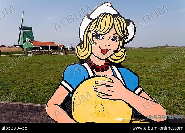 Cardboard cut-out of a Dutch woman in traditional Dutch costume holding cheese, open-air museum Zaanse Schans, Zaanstadt, province of North Holland, Netherlands, Europe.