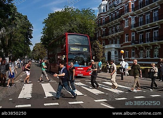 Tourists on the zebra crossing of the famous Beatles album cover, Abbey Road, London, England, United Kingdom, Europe.