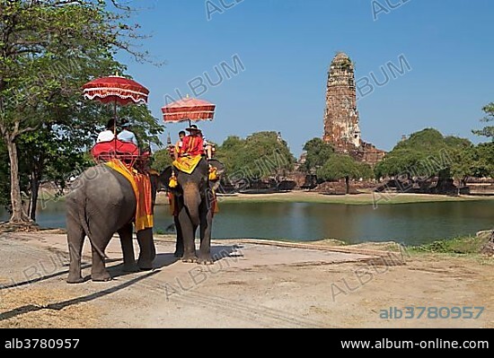 Tourists riding an elephant in front of the Wat Phra Ram temple in the Ayutthaya historical park, Ayutthaya, Thailand, Asia.