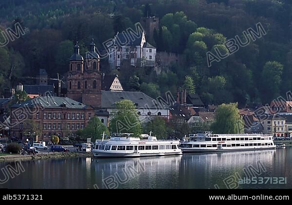 Germany: Miltenberg on the Main river, Bavaria, capital city of the same named county, left: Stadtpfarrkirche , BG: "Mildenburg", front: tourist boats on the Main river in spring time.