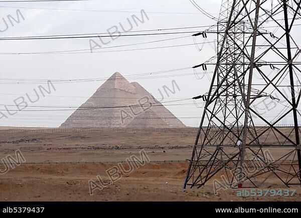 An electricity pylon in front of the Pyramids of Giza, Khafre, Khufu and Menkaure pyramids, Giza, Cairo, Egypt, Africa.