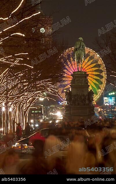 Unter den Linden avenue at Christmas time with statue of Friedrich II, illuminated Ferris wheel, Mitte district, Berlin, Germany, Europe.