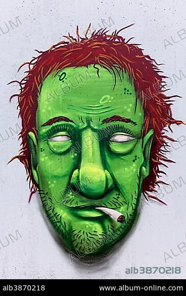 Portrait of a man with a green face smoking weed, hashish or marijuana joint, graffiti, street art, Düsseldorf, North Rhine-Westphalia, Germany, Europe.