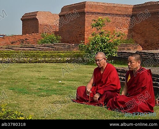 Buddhism, Tibetan monks in red robes in meditation and prayer during the pilgrimage at the archaeological site of the ancient university of Nalanda, Global Buddhist Congregation 2011, Ragir, Bihar, India, Asia.