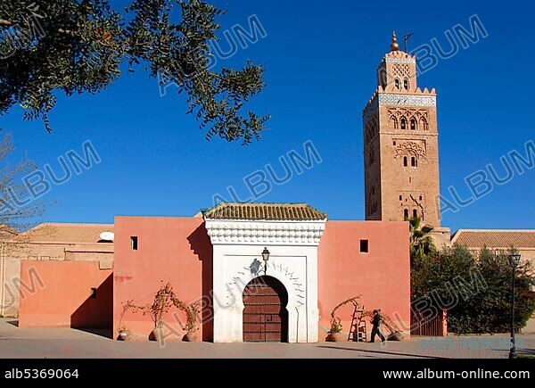Old minaret and entrance gate Koutoubia mosque Marrakech Morocco.