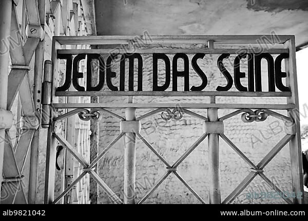 Entrance gate to beech forest concentration camp with the saying JEDEM DAS SEINE in Bauhaus script by Franz Ehrlich; former beech forest concentration camp; today a memorial; black and white; Weimar; Thuringia; Germany; Europe.