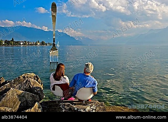 Visitors at the sculpture, The Fork, La Fourchette, by Jean-Pierre Zaugg, in Lake Geneva, Museum of Nutrition Alimentarium, Vevey, Canton of Vaud, Switzerland, Europe.