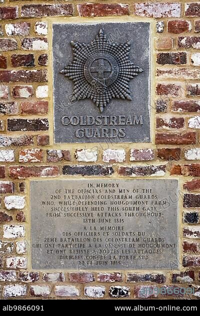 Memorial plaque to the Coldstream Guards at the south gate of the Château d'Hougoumont, farmhouse where British and other allied forces faced Napoleon's Army at the Battle of Waterloo on June 18, 1815, Braine-l'Alleud, Belgium, Europe.