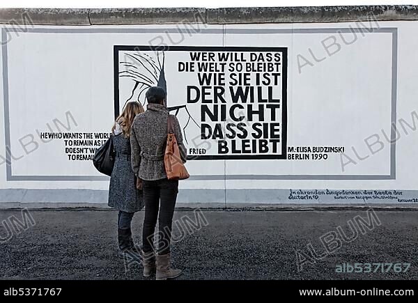 Philosophical quote by Erich Fried on the remants of the Berlin Wall, by Elisa Budzinski, East Side Gallery, Friedrichshain district, Berlin, Germany, Europe *** IMPORTANT: Editorial Use ***.
