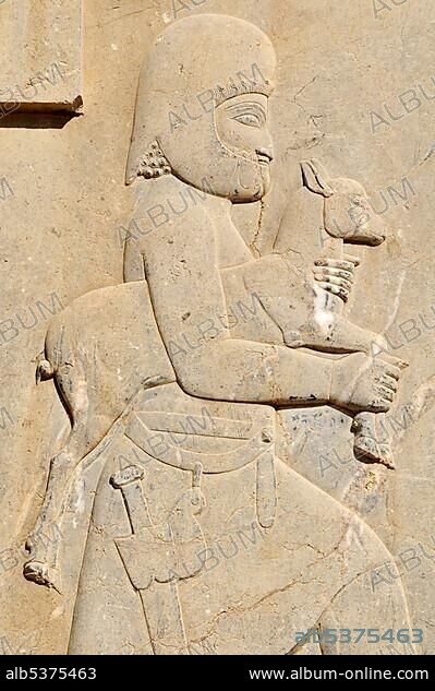 Bas-relief of Median soldier offering a goat at the Achaemenid archeological site of Persepolis, UNESCO World Heritage Site, Persia, Iran, Asia.