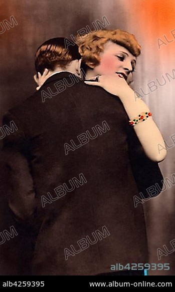 Kissing couple, man hugs and kisses lover on the shoulder, 1920s, Germany, Europe.