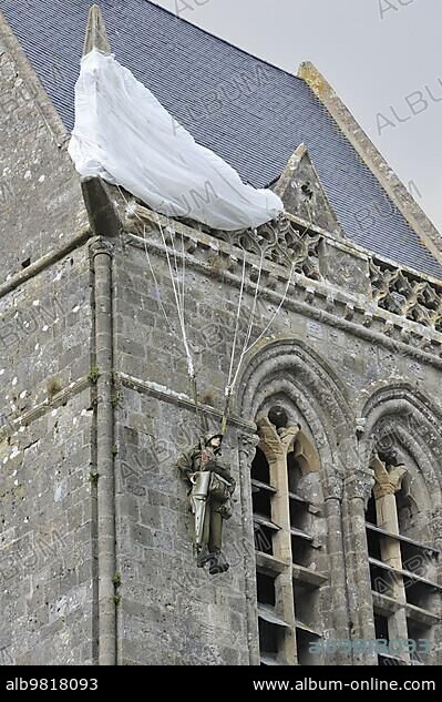 Parachute Memorial in honour of paratrooper John Steele who was caught on the church spire during D-Day; Sainte-Mère-Eglise; Normandy; France; Europe.