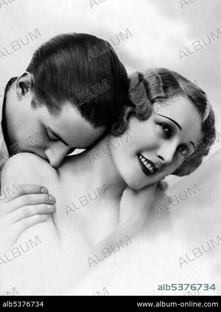 Historic photo, man kissing woman on the shoulder, ca. 1925.