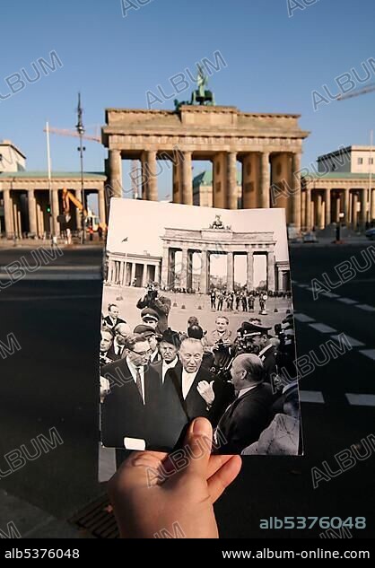 Then and now, hand holding a black and white photo of Konrad Adenauer in front of the Brandenburger Tor or Brandenburg Gate, Berlin, Germany, Europe.