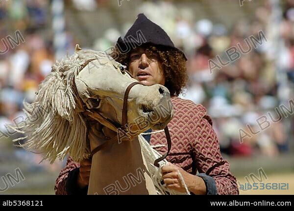 Man with mediaeval medieval costume rides on a horse dummy, knight festival Kaltenberger Ritterspiele, Kaltenberg, Upper Bavaria, Germany, Europe.