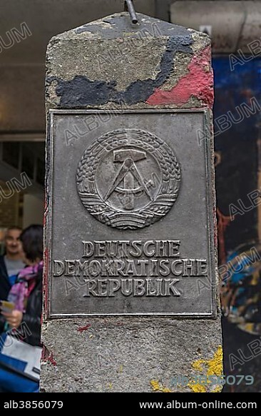 Old concrete pillar of the Inner German border with sign Deutsche Demokratische Republik or German Democratic Republic, Berlin, Germany, Europe.