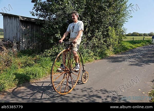 Historical bike, Viehabtrieb festival [ceremonial driving down of cattle from the mountain pastures into the valley in autumn] in Simmershausen, Rhoen, Hesse, Germany, Europe.