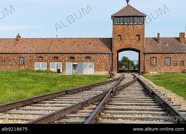 Auschwitz, Poland - 15 September, 2021: view of the gatehouse and train tracks at Auschwitz Concentration Camp in Poland.