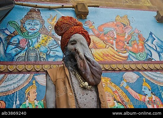 Physically disabled Sadhu, holy man, at one of the ghats of the historic city of Varanasi, India, Asia.