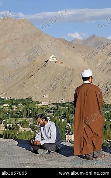 Imam, prayer leader in Islamic prayer, visiting the Buddhist Shanti stupa in Chanspa, Leh, Ladakh, Northern India, the Himalayas, Asia.