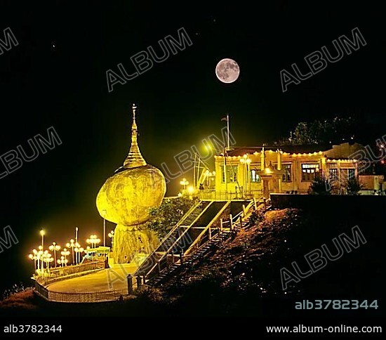 Golden Rock or Kyaiktiyo Pagoda illuminated at night with a full moon, Kyaikto, Mon-Staat, Myanmar, Burma, Asia.