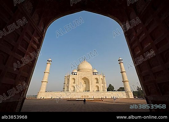 Taj Mahal, UNESCO World Heritage Site, seen through one of the huge gates of the surrounding buildings, Agra, Uttar Pradesh, India, Asia.