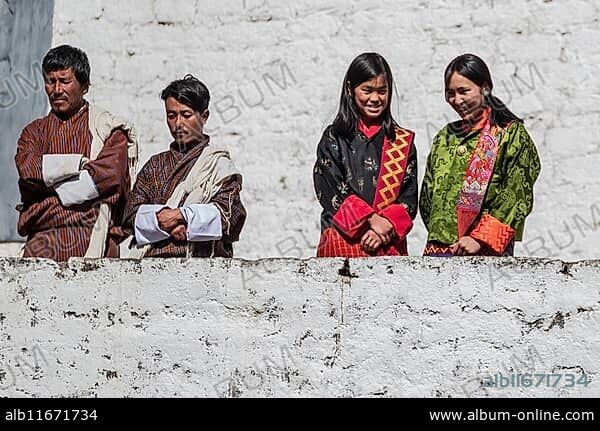 Bhutanese people in traditional clothes watching the annual Tsechu of Trongsa Dzong, Bhutan, Asia.