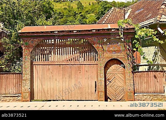 Traditional folk art painted and carved wooden Szekely gate, near Cluj Napoca, Romania, Europe.
