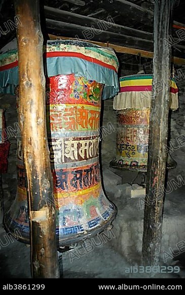 Very old prayer wheels with coloured Nepali script Braga Gompa Annapurna Region Nepal.