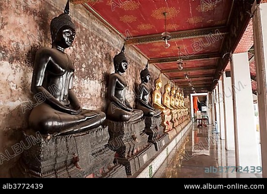 Black Buddha statues, gilded through donations, Buddhist temple, Wat Suthat, Bangkok, Thailand, Southeast Asia, Asia.