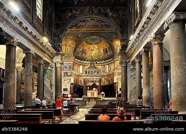 Nave with antique Ionic columns, triumphal arch, altar with marble ciborium or canopy and apse during mass, Basilica Santa Maria in Trastevere, Rome, Lazio, Italy, Europe.