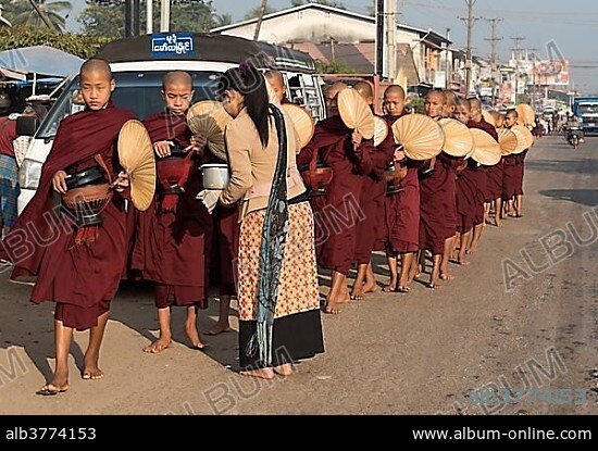 Monks on morning alms round in the streets of Mawlamyine, Mawlamyaing, Mon State, Burma, Myanmar, Asia.