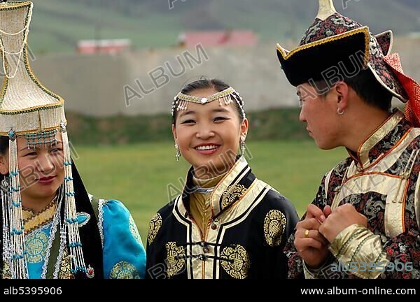 Two women and a man wearing traditional Mongolian national costumes, Ulan Bator or Ulaanbaatar, Mongolia, Asia.