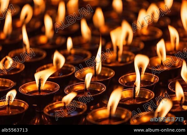 Burning candles in Buddhist temple, Dharamsala, Himachal Pradesh.