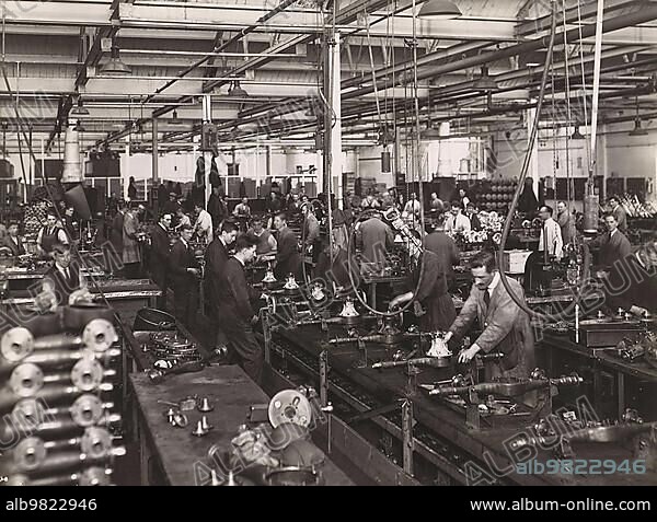 History of the Automobile; Wolseley factory interior with workers at machinery; 1932; Wolseley Motor Company was a British automobile manufacturer; digitally restored reproduction from a 19th-20th century original.
