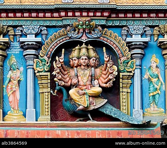 Hindu god Skanda or Murugan, also known as Karttikeya, Subramanya or Kumara with twelve arms and five heads on his mount, the peacock, on a temple wall, Meenakshi Amman Temple or Sri Meenakshi Sundareswarar Temple, Madurai, Tamil Nadu, India, Asia.